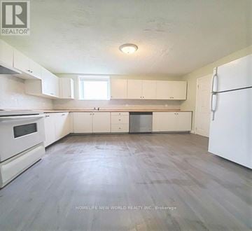 Barrie (Georgian Drive) apartment for rent - A kitchen with white appliances and cabinets.