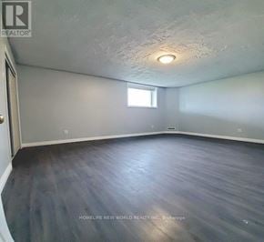 Barrie (Georgian Drive) apartment for rent - A room with a window and wooden flooring.