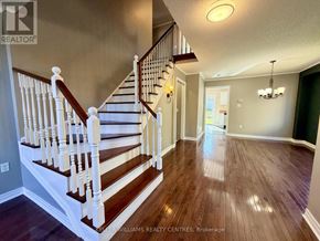 Barrie (400 West) apartment for rent - A well-lit, spacious hallway with a staircase and a chandelier.