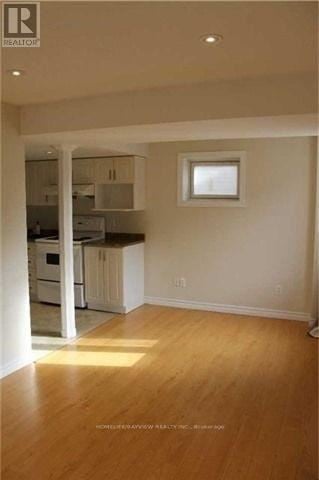 Richmond Hill (Jefferson) townhouse for rent - A well lit kitchen with wooden floors and white walls.