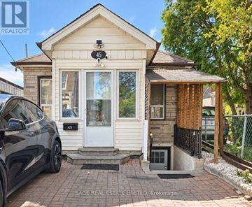Toronto (Weston-Pellam Park) apartment for rent - A small house with a car parked in front of it.
