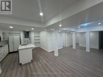 Richmond Hill (Westbrook) apartment for rent - A spacious kitchen with white cabinets and a sink is shown in this image.