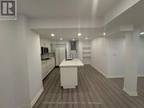 Richmond Hill (Westbrook) apartment for rent - A spacious kitchen with white cabinets and a central island.