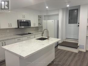 Richmond Hill (Westbrook) apartment for rent - A kitchen with white cabinets and a marble countertop.