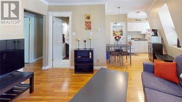 St. John's house for rent - A living room with a grey couch and a wooden floor.