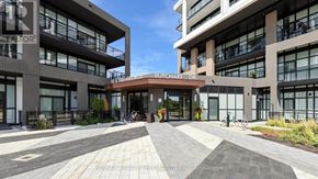 Toronto (Downsview-Roding-Cfb) condo for rent - A modern building with a glass facade and a bicycle parked in front.