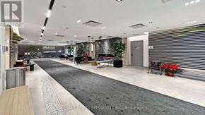 Toronto (Downsview-Roding-Cfb) condo for rent - A modern office lobby with a black and white carpet, a Christmas tree, and a reception desk.