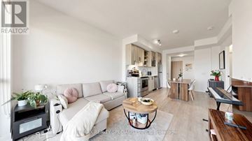 Toronto (Downsview-Roding-Cfb) condo for rent - A modern living room with a white sofa and a coffee table in the center.