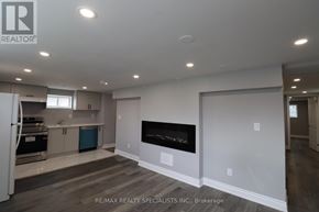Brampton (Northwood Park) apartment for rent - A spacious living room with a fireplace and a kitchen area in the background.