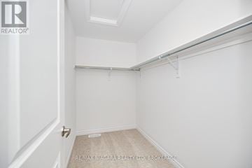 Welland (Lincoln/Crowland) apartment for rent - A white bedroom with a door and a bed in the corner.