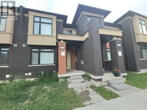 Brampton (Northwest Brampton) townhouse for rent - A brick house with a red door and a small porch.