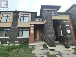Brampton (Northwest Brampton) townhouse for rent - A brick house with a sign that says "HOMELIFE/MIRACLE REALTY LTD, Brokerage".