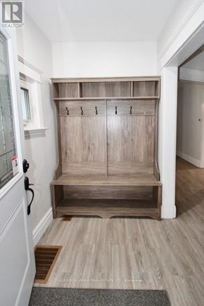 London East (East G) apartment for rent - A wooden bench with storage space is in the corner of a room.