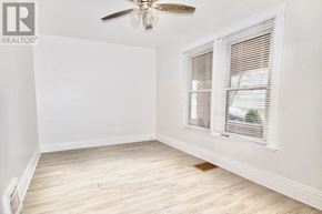 London East (East G) apartment for rent - A room with a ceiling fan and a window with blinds.