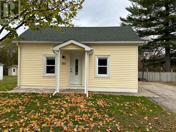 Collingwood apartment for rent - A small yellow house with a grey roof and a white door.