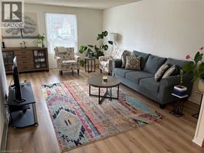 Waterloo apartment for rent - A living room with a grey couch and a rug with a face on it.