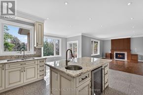 Toronto (Willowdale East) apartment for rent - A modern kitchen with a large island and a fireplace in the living room.