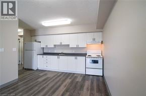Waterloo apartment for rent - A kitchen with white cabinets and a stove top oven.