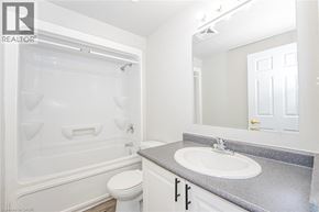 Waterloo apartment for rent - A white bathroom with a toilet, sink, and tub.