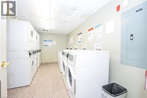 Waterloo apartment for rent - A laundry room with a row of washers and dryers.