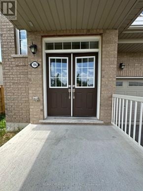 Brantford apartment for rent - The front door of a house with a glass window and a brown door.