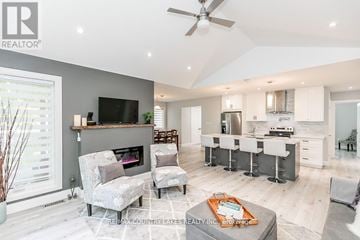 Ramara (Brechin) apartment for rent - A modern living room with a fireplace and a television mounted above it.
