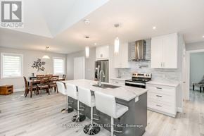 Ramara (Brechin) apartment for rent - A modern kitchen with white cabinets and a center island.