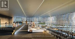 Mississauga (City Centre) condo for rent - A modern indoor space with people sitting by the pool.