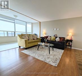 Mississauga (City Centre) condo for rent - A living room with a couch, a coffee table, and a rug.