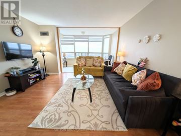 Mississauga (City Centre) condo for rent - A living room with a black couch and a coffee table.