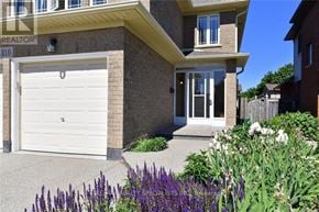 Hamilton (Kernighan) multi-family for rent - A house with a white garage door and a brick facade.