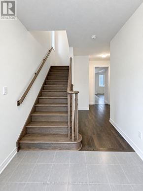 Welland (Dain City) apartment for rent - A wooden staircase with a metal handrail leads to a doorway.