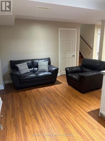 Whitby (Brooklin) apartment for rent - A living room with a black couch and a black chair.