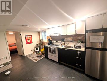 Toronto (Dovercourt-Wallace Emerson-Junction) apartment for rent - A kitchen with black cabinets and stainless steel appliances.