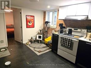 Toronto (Dovercourt-Wallace Emerson-Junction) apartment for rent - A kitchen with a stove top oven and a fridge.