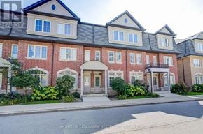 Toronto (L'amoreaux) townhouse for rent - A red brick building with a black roof and white trim.