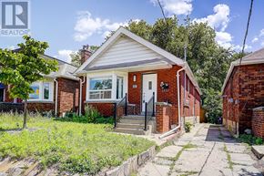 Toronto (Broadview North) apartment for rent - A small red brick house with a white door and a small porch.