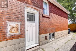 Toronto (Broadview North) apartment for rent - A red brick house with a white door and a window.