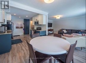 Newmarket (Huron Heights-Leslie Valley) apartment for rent - A well-lit kitchen and dining area with a table and chairs.