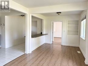 Vaughan (Maple) apartment for rent - A spacious room with white walls and wooden flooring.