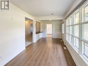 Vaughan (Maple) apartment for rent - A long, empty hallway with wood floors and white walls.