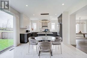 East Gwillimbury (Queensville) apartment for rent - A modern kitchen with a glass table and chairs.