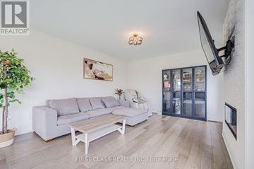 East Gwillimbury (Queensville) apartment for rent - A living room with a grey couch and a wooden coffee table.