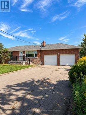 Milton (Mn Milton North) apartment for rent - A house with a garage and a driveway in front of it.
