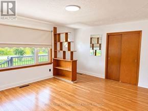 Milton (Mn Milton North) apartment for rent - A room with a wooden floor and a large window with blinds.