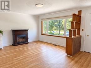Milton (Mn Milton North) apartment for rent - A room with a fireplace and wooden floors.