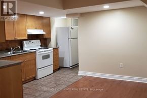 Mississauga (Churchill Meadows) apartment for rent - A kitchen with a white stove top oven and a white refrigerator.