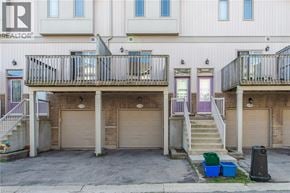 Waterloo townhouse for rent - A building with a balcony and a garage door.