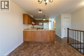 Waterloo townhouse for rent - A realtor's office with a wooden counter and a staircase.