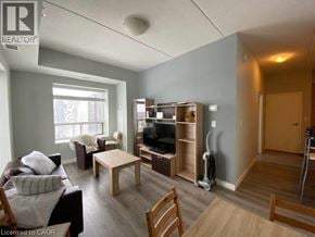 Waterloo condo for rent - A living room with a couch, chairs, and a television.